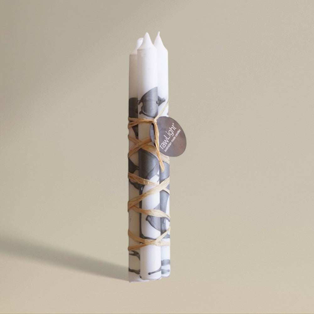 Three white-and-silver splashed Christmas dining candles