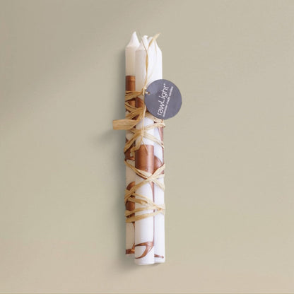 Three white-and-copper splashed Christmas dining candles