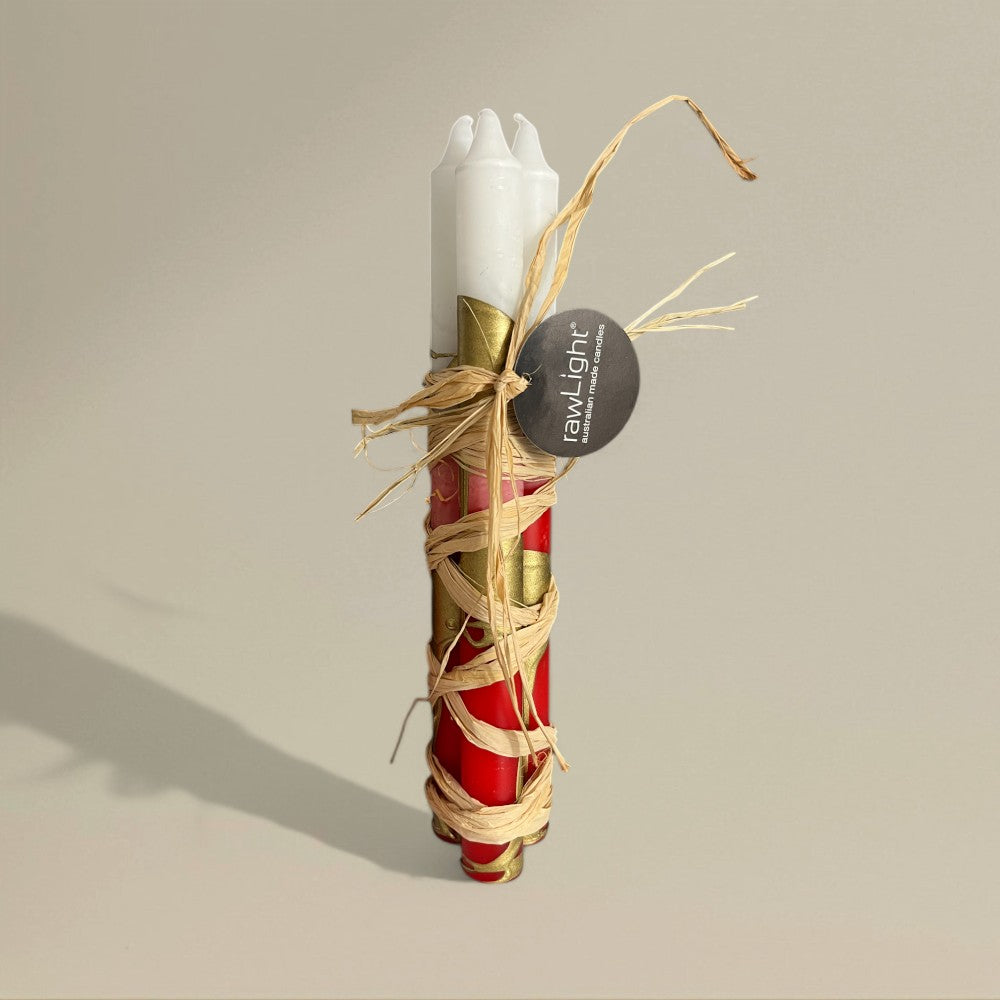 Three red, white and gold splashed Christmas dining candles