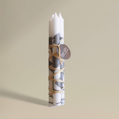 Three white-and-silver splashed Christmas dining candles